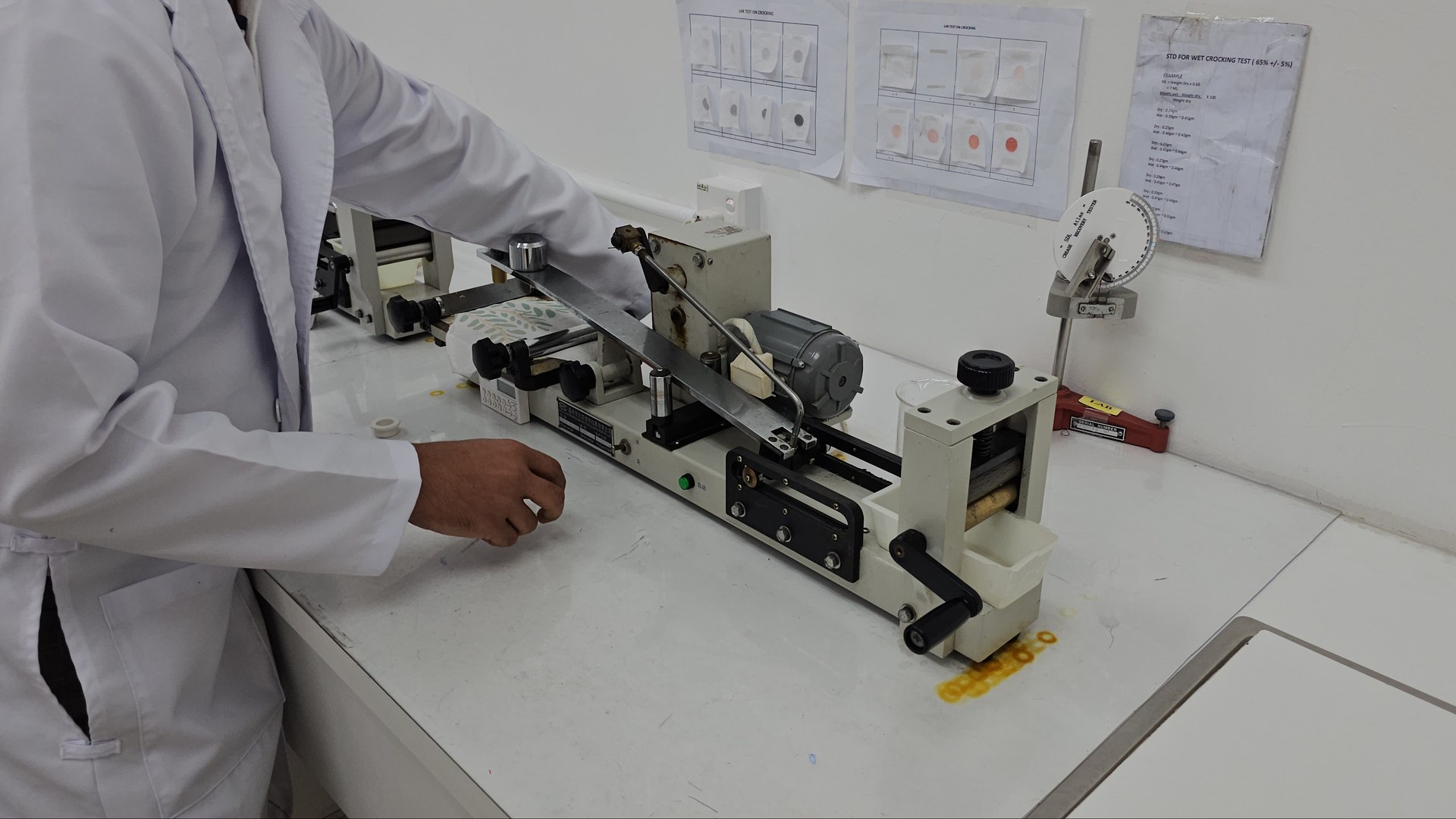 Technician running a crockmeter rubbing test for colourfastness